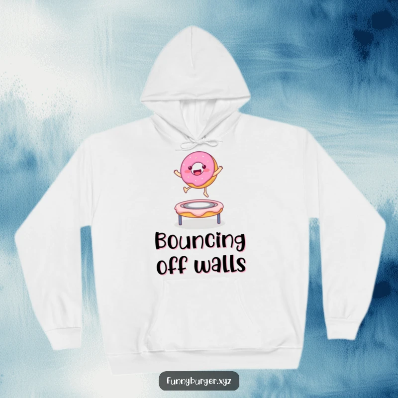 Funny hoodie showcasing a happy donut character bouncing on a frosting trampoline, a warm and delightful item.